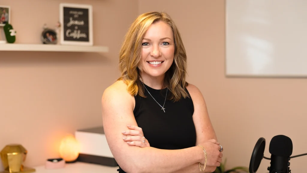 Business Strategist Jennifer Sakowski poses in her office with arms crossed and a smile