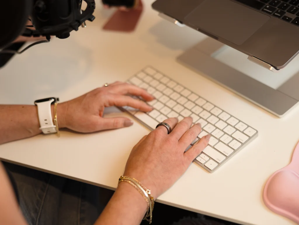 hands typing on a keyboard