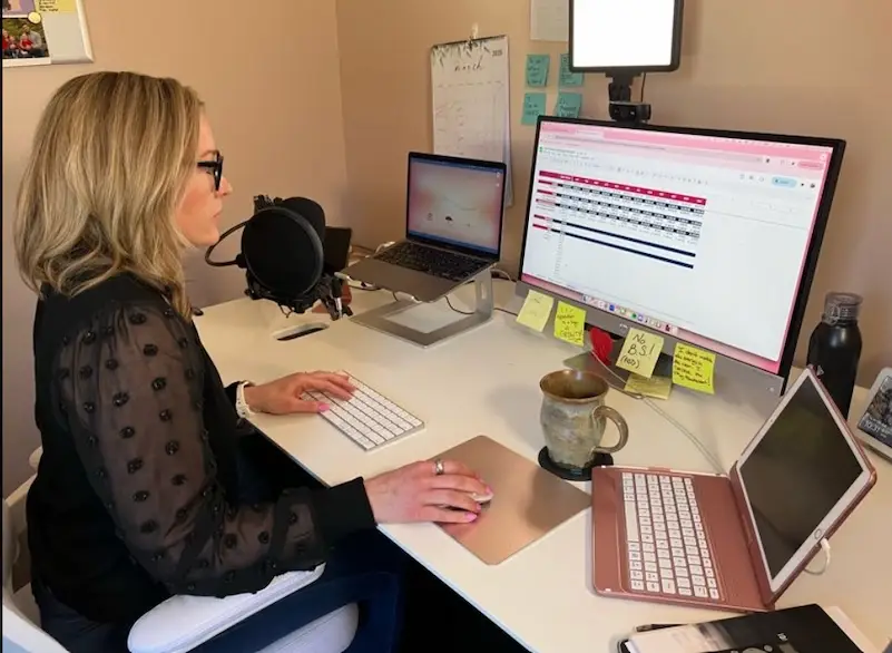 Marketing guru and Raney Day Design Founder, Jennifer Sakowski, sits at her desk, focusing on running her business