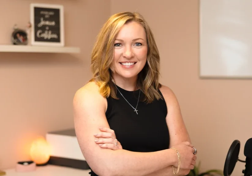 Business Strategist Jennifer Sakowski poses in her office with arms crossed and a smile